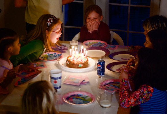 Nenes a una festa d'aniversari a punt de bufar les espelmes del pastís- Jesse Millan - Flickr - CC BY 2.0